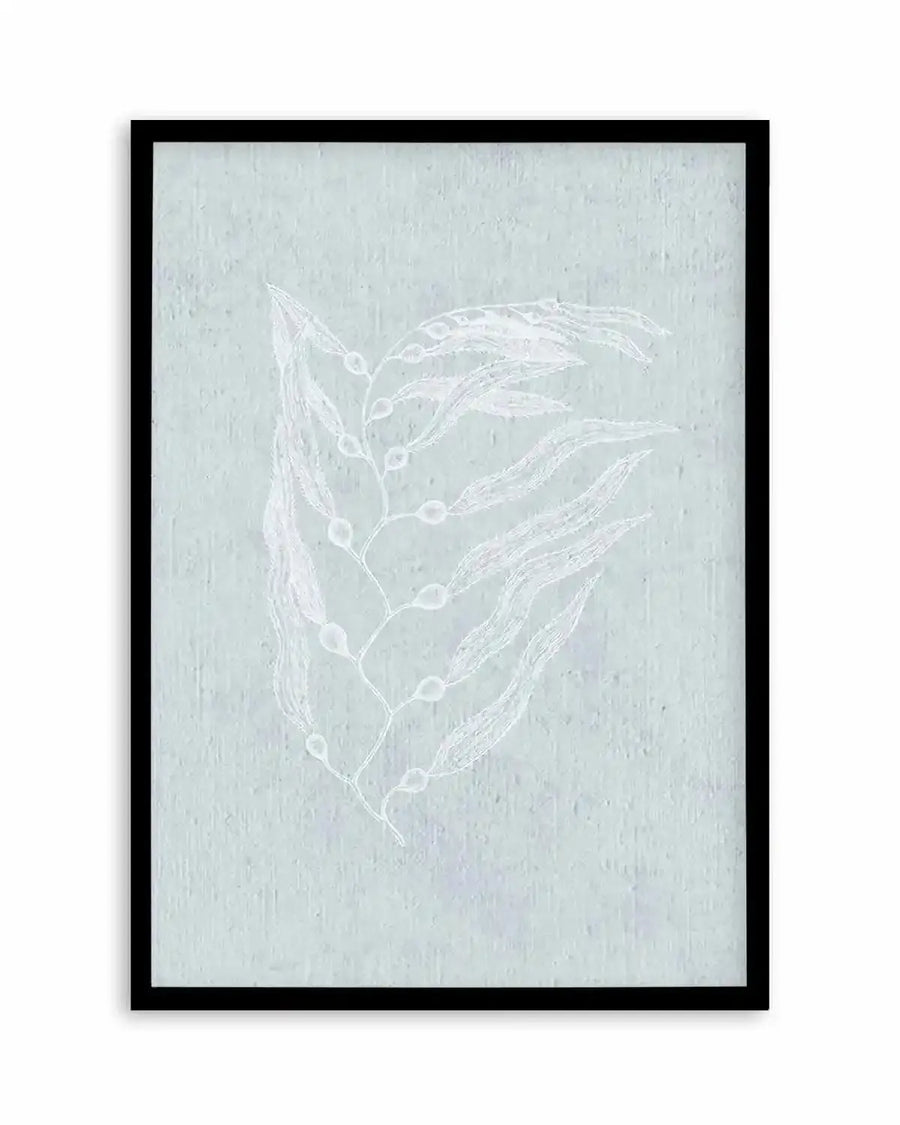 Framed art print featuring delicate white botanical line drawings on a soft sage green textured background. The composition shows two elongated leaf sprigs with small circular seed pods or buds arranged vertically. The artwork has a minimalist, hand-drawn quality with fine linework. The print is set in a black frame with white border.