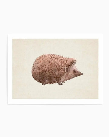 Watercolour illustration of a hedgehog in profile facing left, rendered in warm taupe and dusty rose tones against a pale cream background. The hedgehog's spines are depicted with fine brushstrokes showing texture and dimension, while its small dark eye and pointed snout are delicately detailed. The artwork is displayed as a framed print with a white border on linen-textured paper, creating a soft, naturalistic aesthetic.