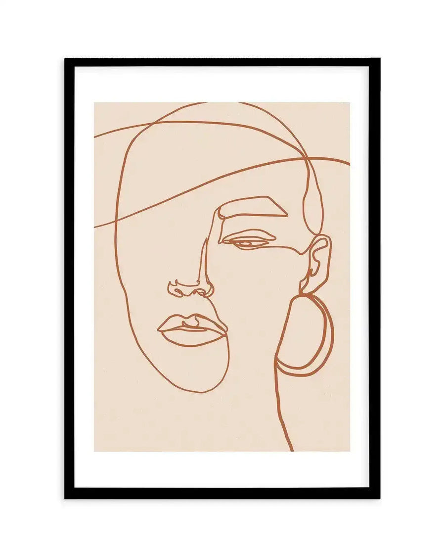 Art print featuring a minimalist line drawing of a woman's face in terracotta brown on a cream background, displayed in a black frame with white border. The continuous line forms the outline of her head, nose, lips, and a partially visible eye, with an abstract line crossing the top of her head and a large hoop earring on the right side.