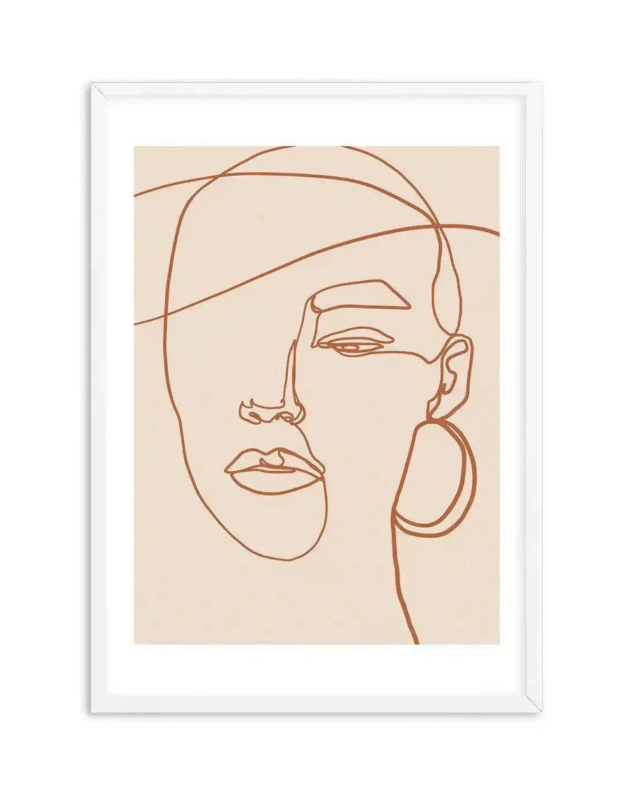Line art print featuring a minimalist abstract depiction of a woman's face in a continuous terracotta brown line on a warm cream background, displayed in a white frame with a white border. The composition shows the left side of the face in detail, with the right side partially obscured by the continuous line.