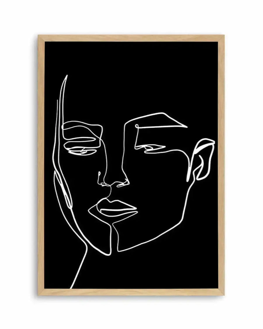 Art print featuring a minimalist continuous line drawing of a woman's face in white on a black background, displayed in a natural oak frame with white border. The artwork captures the contours of her face, with emphasis on the eyes, nose, and lips, rendered with fluid, unbroken lines.