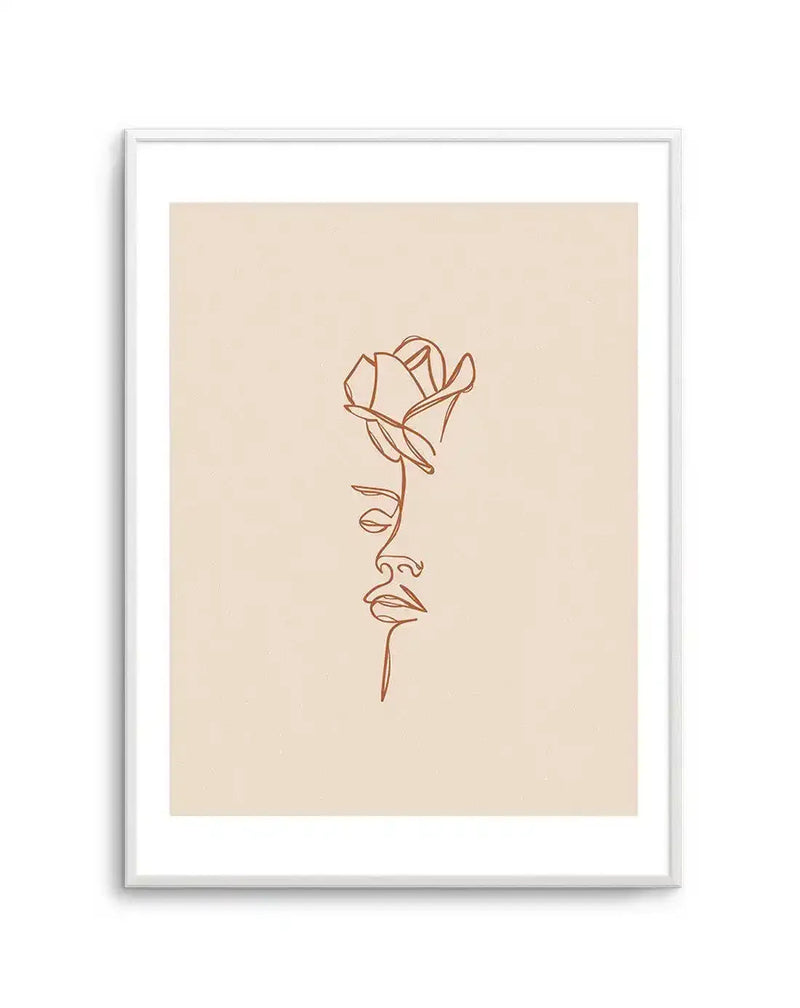 Line art print featuring a continuous single line drawing of a woman's face in profile, with a rose blooming from her head, in a terracotta hue on a cream background, displayed in a white frame with white border.