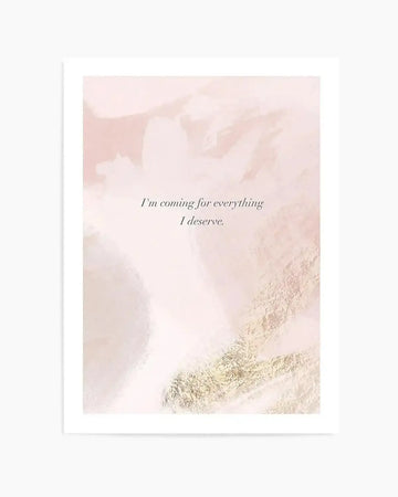 Abstract art print with a soft, ethereal background in shades of blush pink, cream, and pale peach, featuring areas of shimmering gold foil texture. The print displays the quote "I'm coming for everything I deserve." in elegant serif font.