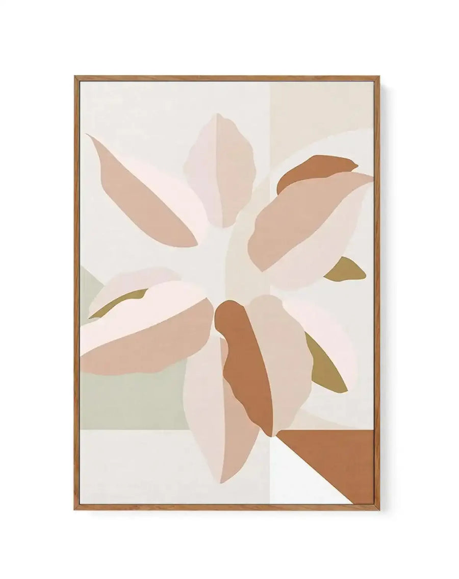 Framed canvas art print titled "In Bloom I" featuring an abstract floral composition. The design displays stylized flower petals in soft, muted tones including dusty rose, warm tan, terracotta brown, and olive green arranged in a circular blooming pattern against a cream and light beige background. The illustration uses a flat, geometric style with layered, overlapping petal shapes creating depth. The artwork is mounted in a natural wood-tone frame with a white border, presented in portrait orientation.