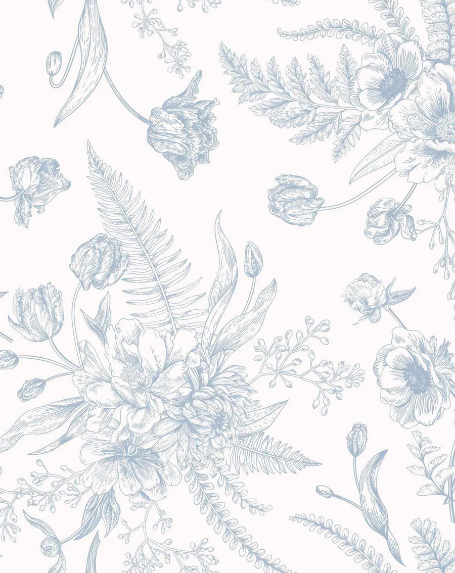 Peel and stick wallpaper featuring a repeating pattern of hand-drawn botanical illustrations in a soft, muted blue on a light cream background. The design includes various flowers like tulips, peonies, and anemones, along with ferns and other leafy branches, arranged in loose bouquets and scattered individual elements, creating a classic, elegant aesthetic.