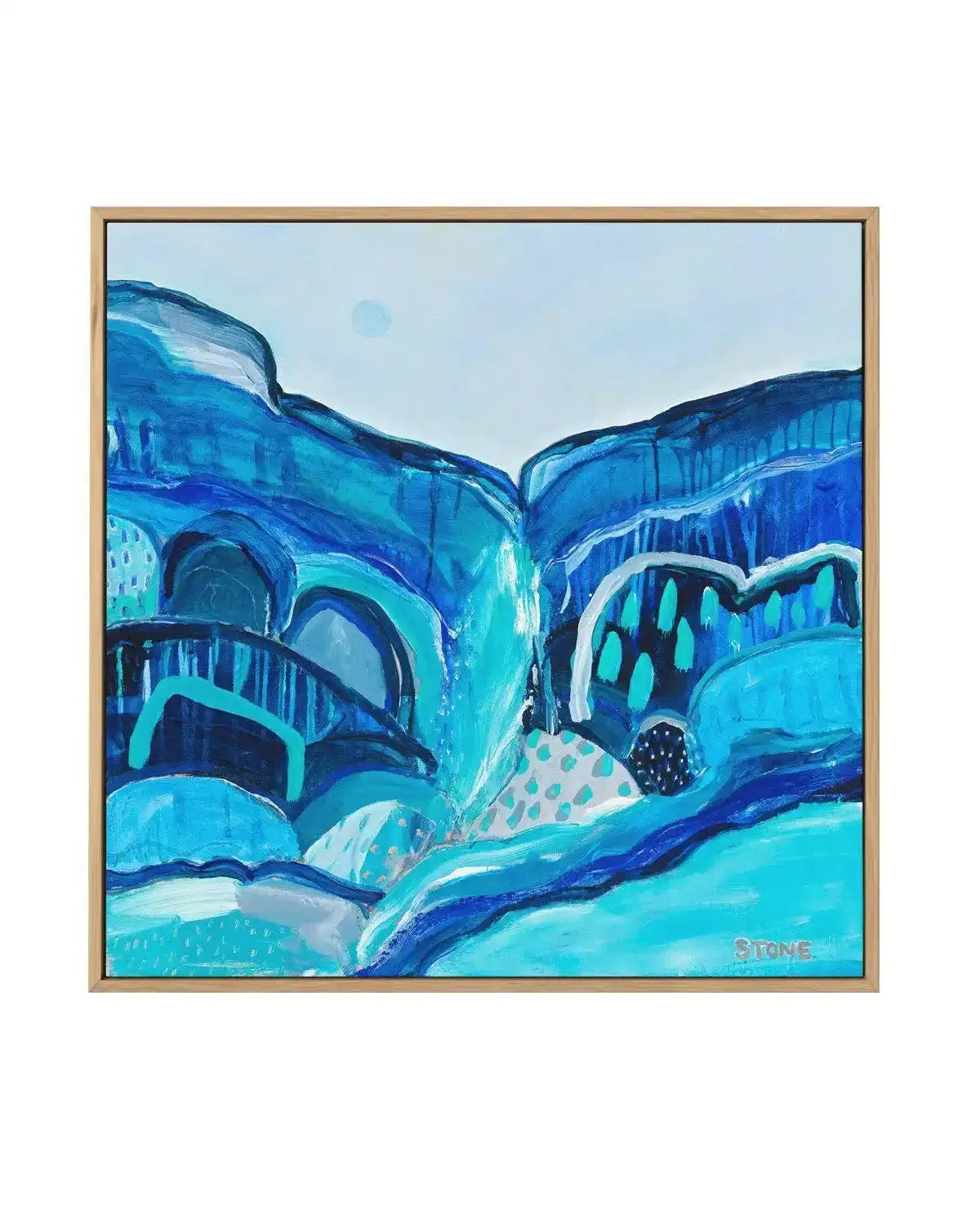 Abstract canvas print featuring a dynamic landscape of layered shapes and textures in various shades of blue, from deep navy to bright turquoise, with hints of white and grey. The composition suggests a valley or gorge with flowing water and organic forms, rendered with visible brushstrokes and speckled patterns, displayed in a natural oak frame.