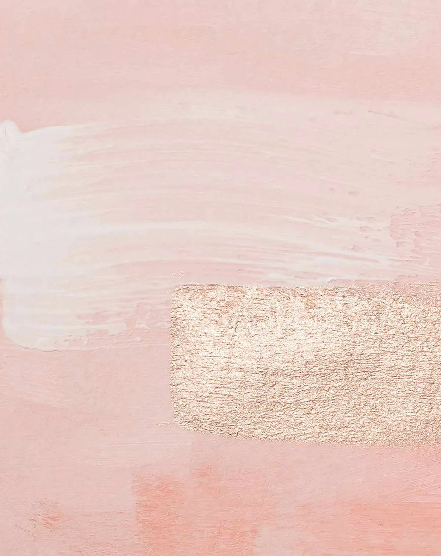 Peel and stick wallpaper featuring an abstract design with a base of soft blush pink, overlaid with a broad horizontal stroke of creamy white paint across the upper half, and a rectangular block of textured rose gold foil in the lower right. The design has a painterly quality with visible brushstrokes and a slightly distressed finish.