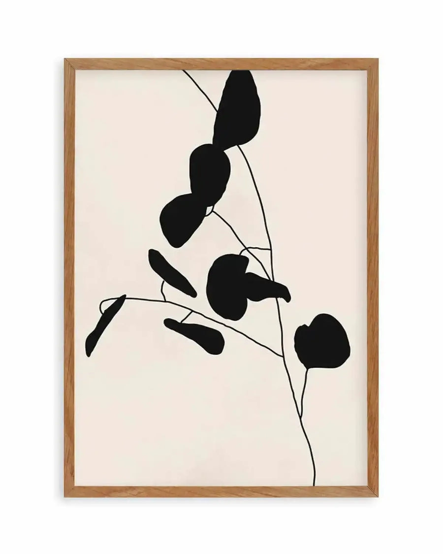 Abstract art print featuring minimalist black silhouettes of organic leaf shapes on thin, delicate stems against a warm cream background, displayed in a natural oak frame with white border.