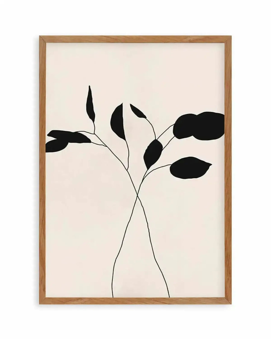 Art print featuring two minimalist line art plant stems with abstract black leaves on a cream background, printed on fine art paper and displayed in a natural oak frame with white border