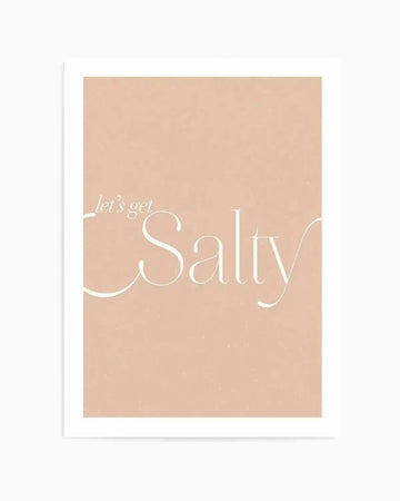 Art Print:
Art print featuring the phrase "let's get Salty" in a delicate, flowing script against a soft, muted peach background with a subtle textured finish. The words are rendered in a creamy off-white colour, with "let's get" in a smaller, more casual font above the larger, elegant "Salty."