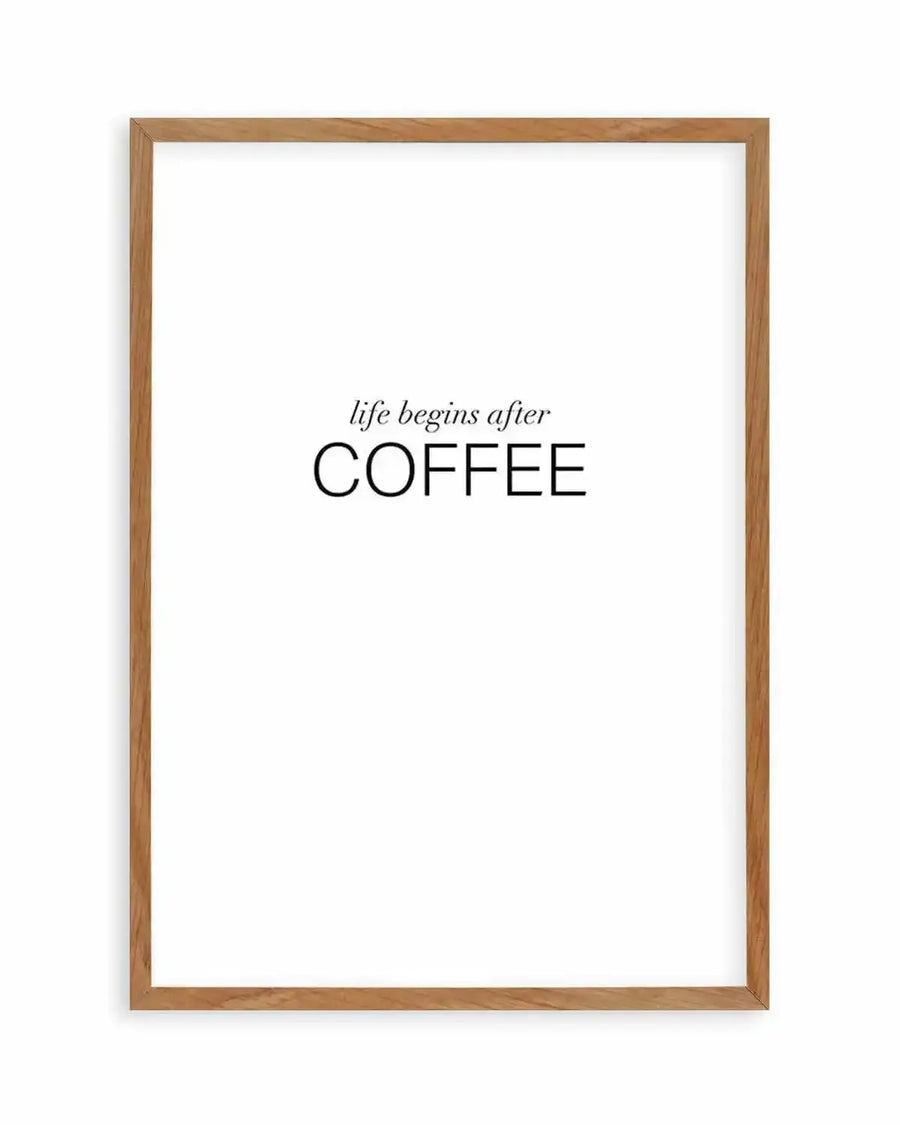 Art print featuring the phrase "life begins after COFFEE" in black text on a white background, displayed in a natural oak frame with white border. The word "life begins after" is in a smaller, elegant script font, while "COFFEE" is in a larger, bold sans-serif font.