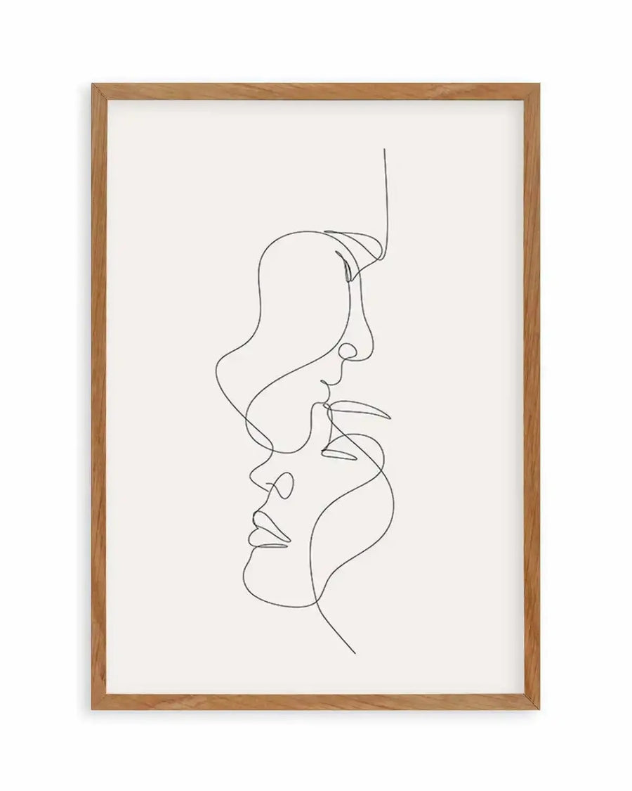 Line art print featuring two faces in profile, one above the other, drawn with a single continuous black line on a white background, displayed in a natural oak frame with white border.