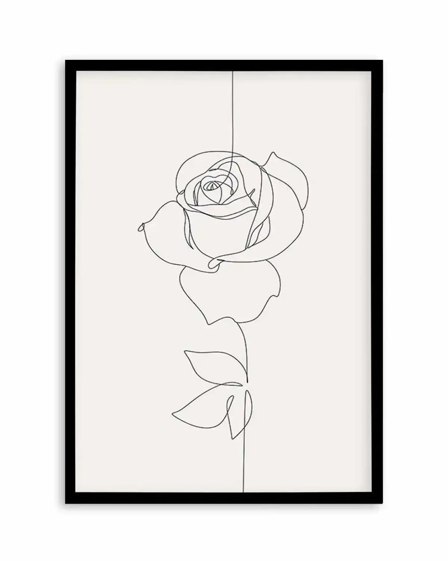 Line art print featuring a single rose drawn with a continuous black line on a cream background, displayed in a black frame with white border. The rose is depicted from bud to stem, with delicate petals and two leaves.