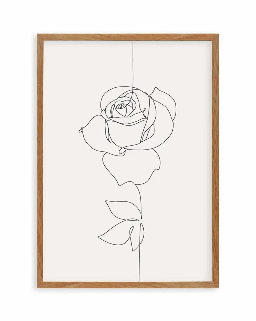 Line art print featuring a single rose in continuous black line on a crisp white background, printed on fine art paper and displayed in a natural oak frame with white border.