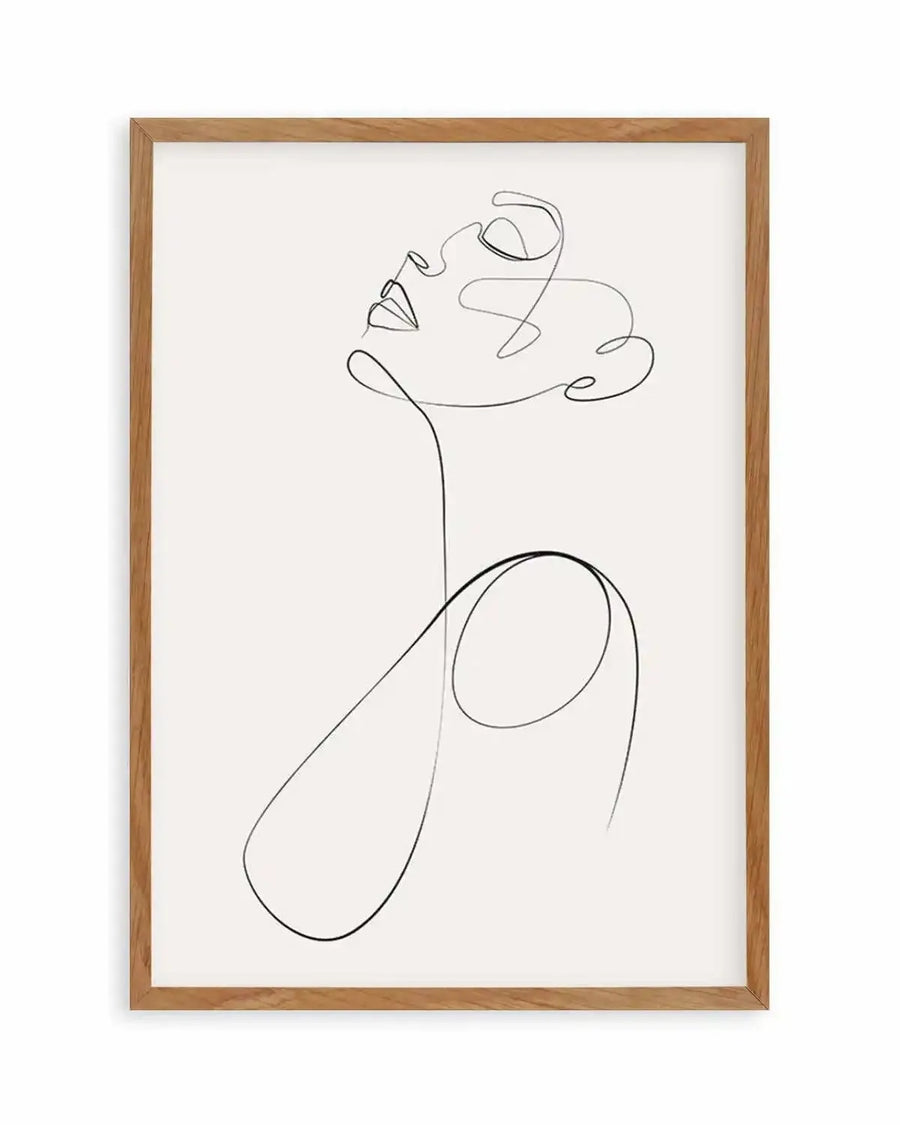 Line art print featuring a single continuous black line forming the profile of a woman's face looking upwards, with a flowing line extending down to suggest the shoulders, displayed in a natural oak frame with white border.