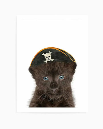 "Photography art print featuring a close-up of a black leopard cub wearing a pirate hat, set against a stark white background. The cub has deep blue eyes and soft black fur, with delicate whiskers visible. The pirate hat is black with an orange trim and features a white skull and crossbones emblem."