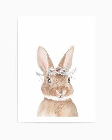 Watercolour art print featuring a fluffy light brown bunny with long ears, facing forward against a white background. The bunny wears a delicate flower crown with small pink, cream, and pale blue flowers, accented with soft grey-green leaves.