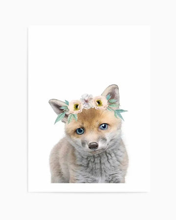 Watercolour art print featuring a baby fox with soft, light brown and grey fur, wearing a delicate flower crown with cream, white, and pale yellow blossoms and light green leaves, set against a clean white background.