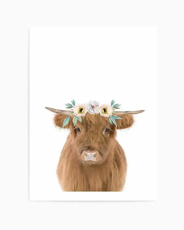 Watercolour art print featuring a fluffy brown Highland cow wearing a flower crown, depicted from the chest up against a plain white background. The cow has shaggy, reddish-brown fur, small horns, and a light pink nose. The flower crown consists of light cream and pale pink flowers with green leaves.
