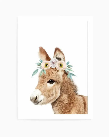Watercolour art print featuring a baby donkey with soft brown fur and large dark eyes, wearing a delicate flower crown with pale pink and yellow blooms and sage green leaves, set against a clean white background.