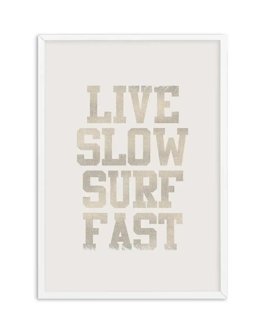 Art print featuring the words "LIVE SLOW SURF FAST" in a distressed, collegiate-style font with a woven texture, in a light beige or off-white color against a solid cream background, displayed in a white frame with a white border.