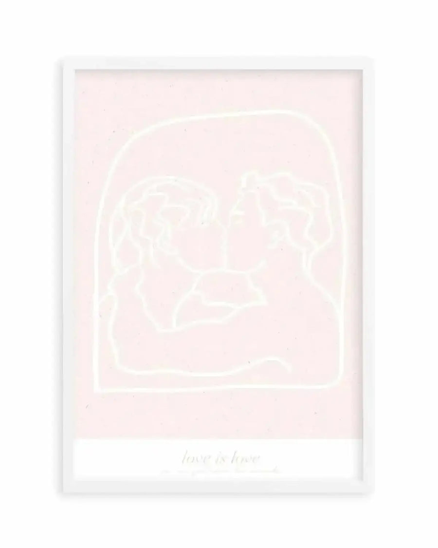 Art print featuring a minimalist line drawing of two figures kissing, enclosed within an arched frame, rendered in a pale cream hue on a soft blush pink background. The print is displayed in a white frame with a white border, and the words "love is love" are subtly printed at the bottom.