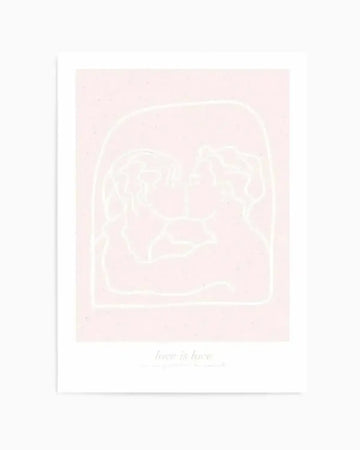 Art print featuring a minimalist line drawing of two figures kissing, outlined in white against a soft blush pink background. The figures are enclosed within a rounded arch shape, with the text "love is love" in a delicate script below the illustration.