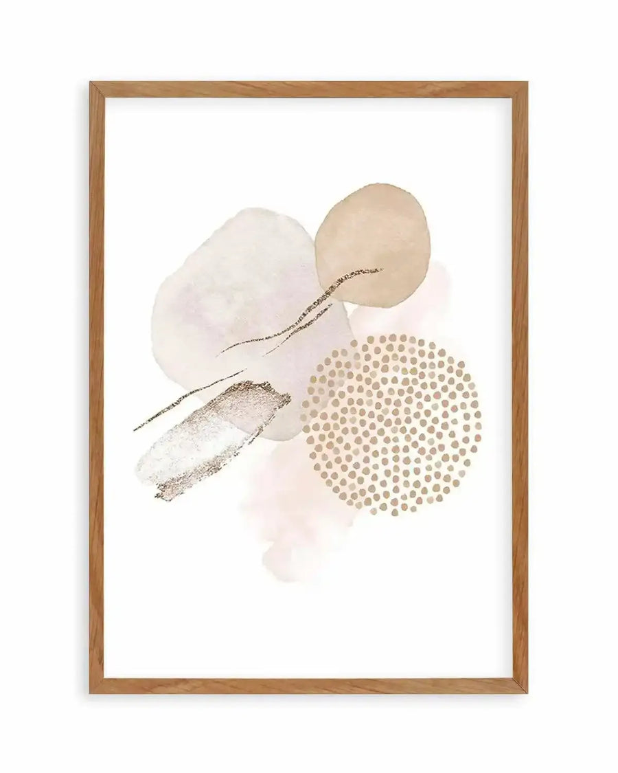 Abstract art print featuring organic shapes and brushstrokes in soft blush pink, beige, and cream, with accents of gold glitter and fine black lines, displayed in a natural oak frame with white border.