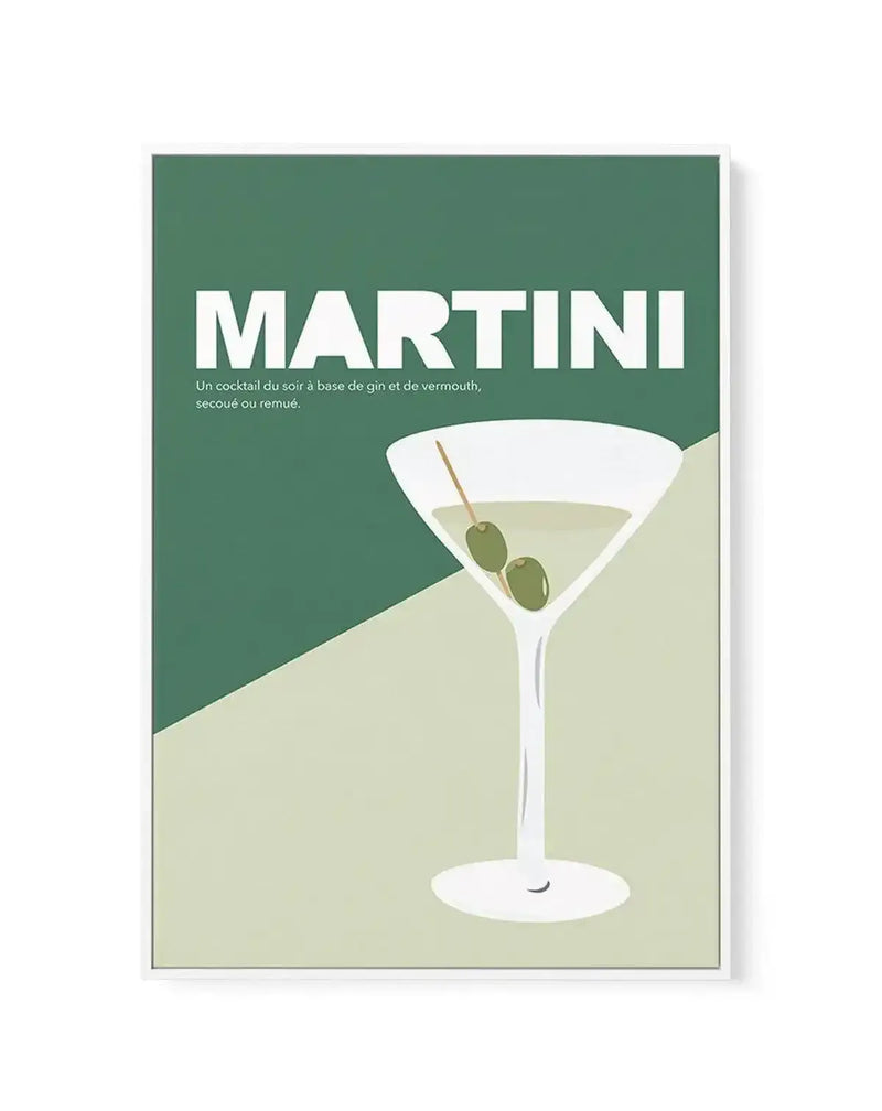 Framed canvas art print featuring a minimalist illustration of a martini cocktail against a two-tone background of deep sage green and pale yellow-green. The martini glass contains a clear liquid and is garnished with two green olives on a cocktail pick. White text reading "MARTINI" appears at the top, with smaller French text below describing the cocktail. The artwork has a clean, geometric style with simple shapes and a soft, matte finish. The canvas is mounted in a slim gray frame with a white border.