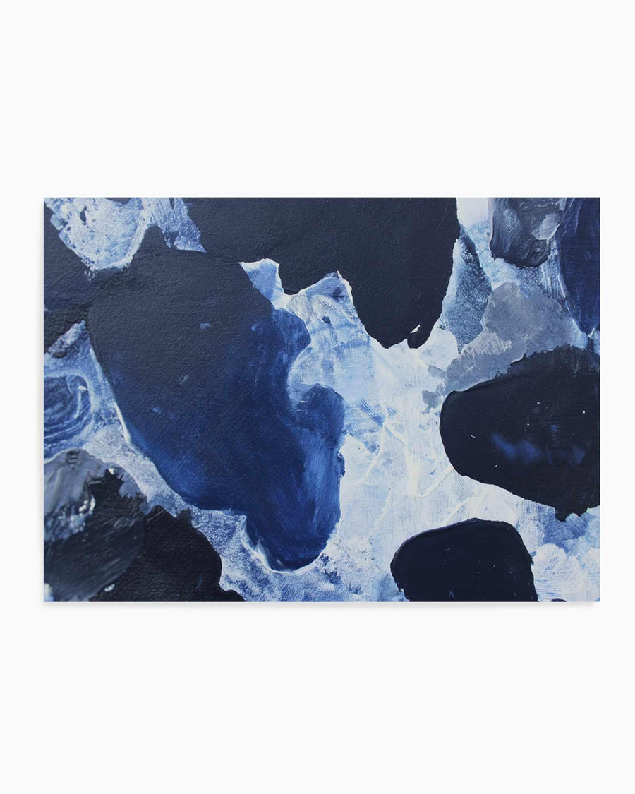 Abstract art print titled "Midnight Current I" featuring a fluid composition of deep navy blue and black organic shapes with pale blue and white accents resembling flowing water or ice formations. The painting has a textured, layered appearance with visible brushstrokes creating depth and movement. The composition uses contrasting dark and light areas to suggest swirling currents or frozen landscapes. The print is displayed with a clean white border against a light background.