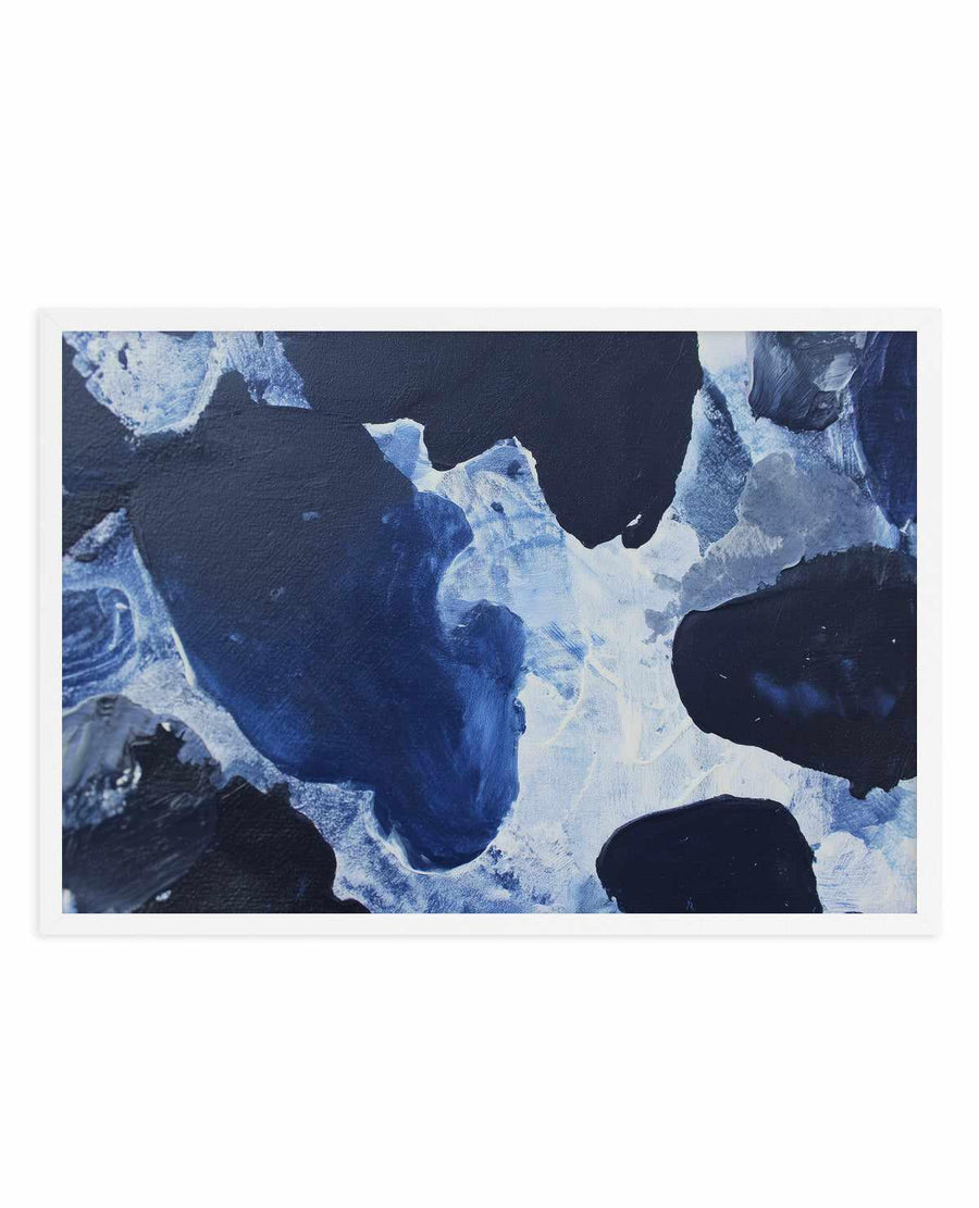 Abstract art print titled "Midnight Current I" featuring swirling brushstrokes in deep navy blue, bright white, and pale blue tones. The composition shows organic, flowing forms reminiscent of water currents or geological formations, with areas of dark navy creating depth against lighter blue and white passages. The painting appears to be acrylic or mixed media with visible brushwork and texture. The print is presented in a white frame with white border, displayed as a horizontal landscape-oriented artwork.