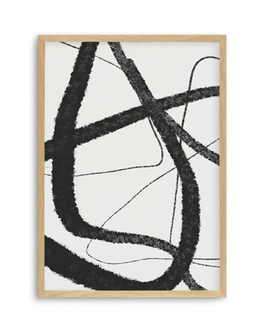 Abstract art print featuring bold, thick, and thin charcoal black brushstrokes forming an intertwined, dynamic composition on a clean white background, printed on fine art paper and displayed in a natural oak frame with white border.