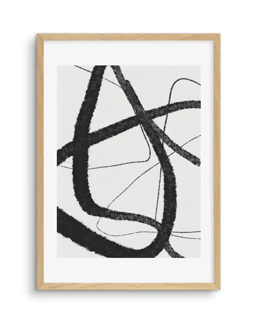 Abstract art print featuring bold, expressive brushstrokes in black on a white background, creating a dynamic composition of intersecting lines and curves. The strokes vary in thickness and intensity, with a textured, almost fuzzy appearance, and are displayed in a natural oak frame with white border.