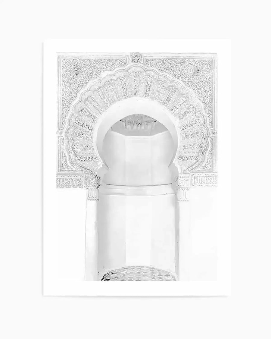 Moroccan arch art print featuring a detailed white archway with intricate carved patterns and calligraphy on a white background, printed on fine art paper with a matte finish.