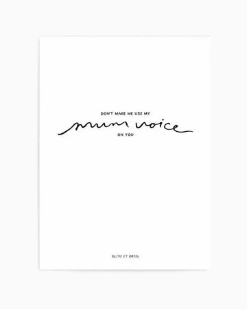Art print featuring black hand-lettered text on a white background reading "DON'T MAKE ME USE MY mum voice ON YOU" with the words "mum voice" written in an expressive, wavy cursive script. The design uses a minimalist aesthetic with clean typography in the upper portion and the stylized script as the focal point. Credit text appears at the bottom. Printed on white paper with a simple, unframed presentation suitable for home décor.
