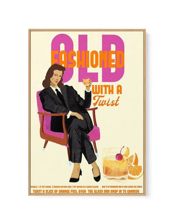 Framed canvas art print featuring a retro-style illustration of a woman in a suit holding a cocktail, with large text reading "OLD FASHIONED WITH A Twist." The woman is seated in a pink chair, and a glass with an Old Fashioned cocktail, orange slices, and a cherry is beside her. The print has a light cream background and is displayed in a natural wood frame.