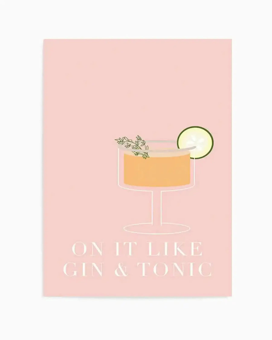 Art print featuring a minimalist illustration of a cocktail glass with an orange drink, garnished with a sprig of thyme and a cucumber slice, on a soft pink background. Below the glass, the text "ON IT LIKE GIN & TONIC" is written in a light cream colour.