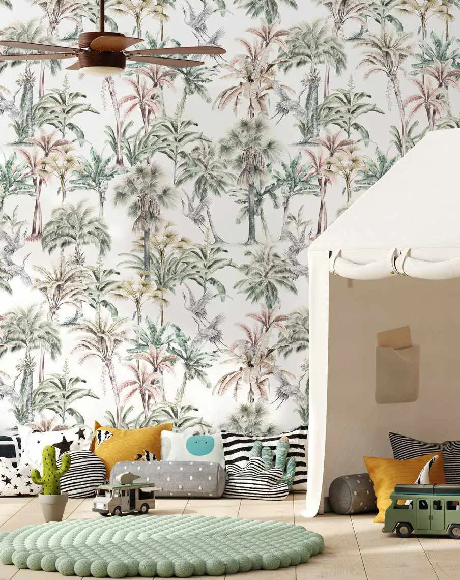 Kids Room:
"Palm Oasis wallpaper featuring a repeating pattern of hand-painted palm trees in various shades of green, pink, and grey against a white background, displayed in a child's room. The room includes a white play tent, a light green textured rug, and various soft pillows and toys on a light wood floor."