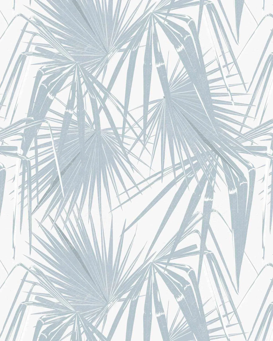 Paradiso in Ocean Wallpaper featuring a repeating pattern of large fan-shaped palm fronds in muted blue-gray tones on a cream background. The fronds radiate outward with fine linear details, creating a tropical botanical design with soft, naturalistic illustration style. The pattern has an airy, layered composition with overlapping leaves that convey movement and depth across the entire surface.