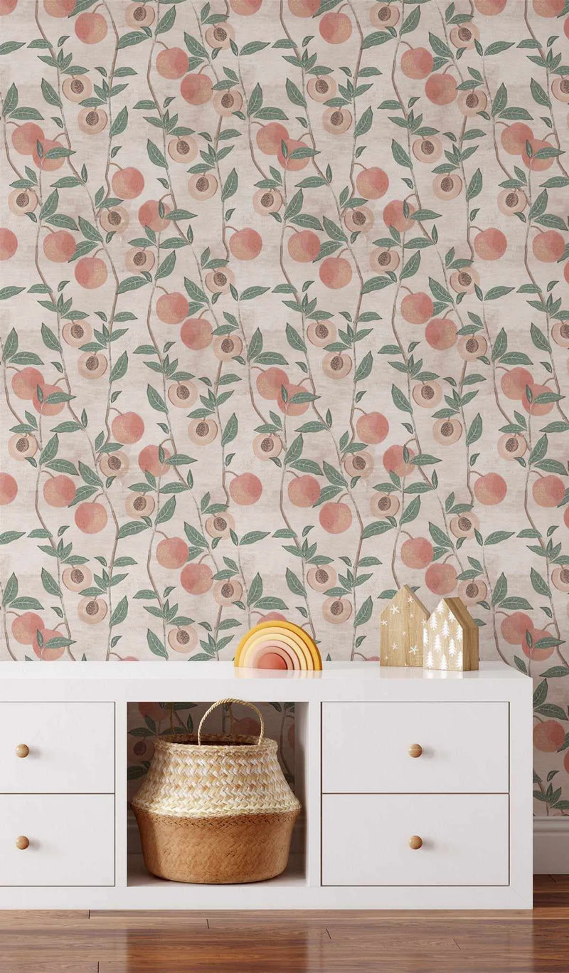 "Peel and stick wallpaper featuring a repeating pattern of hand-painted peach branches with ripe peaches and green leaves on a textured light beige background. The botanical design has a loose, organic watercolour quality with visible brushstroke texture. Some peaches are whole, while others are cut in half, revealing their pits."