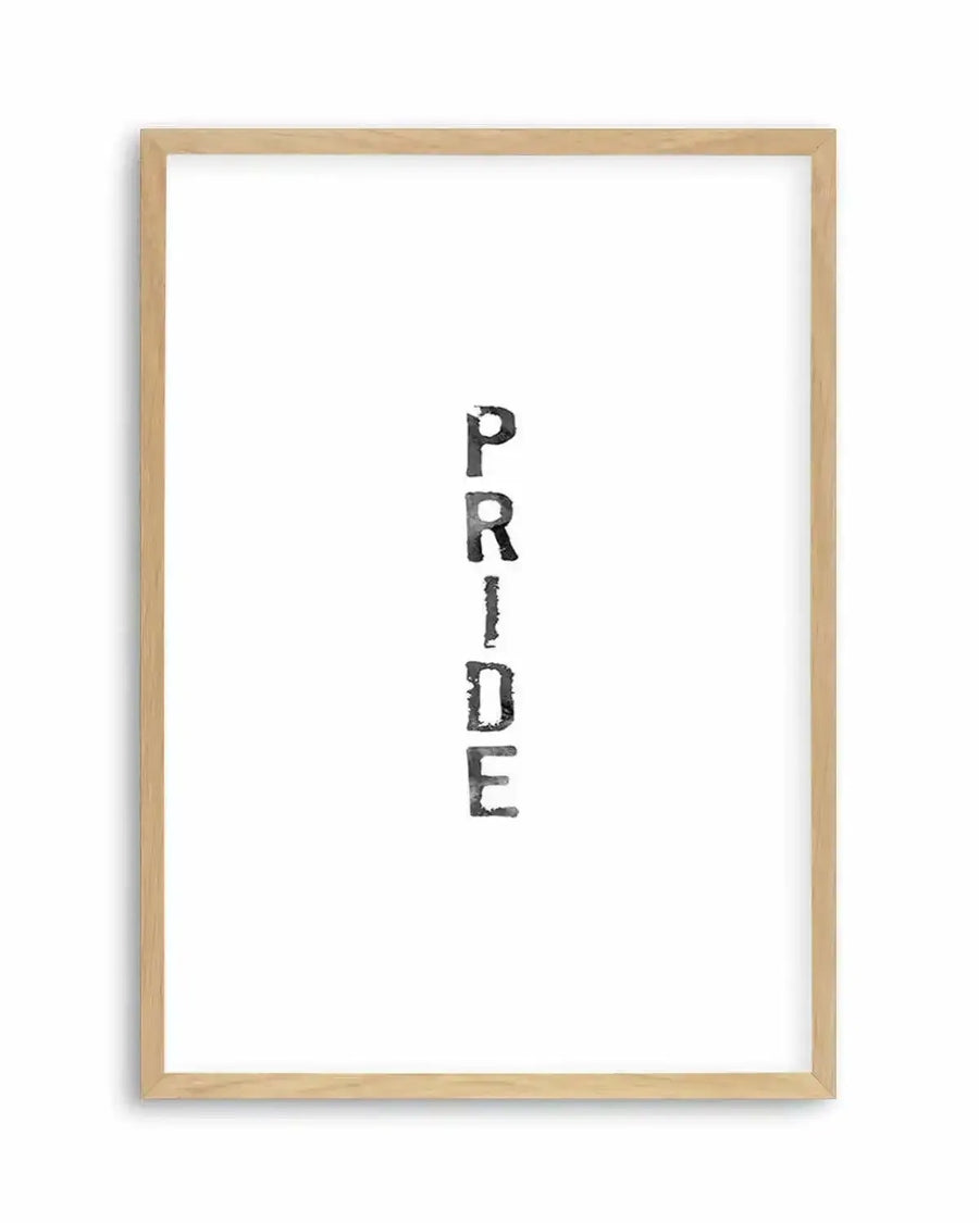 Watercolour art print featuring the word "PRIDE" spelled vertically in distressed black block letters with a textured, slightly faded appearance, printed on fine art paper and displayed in a natural oak frame with white border.