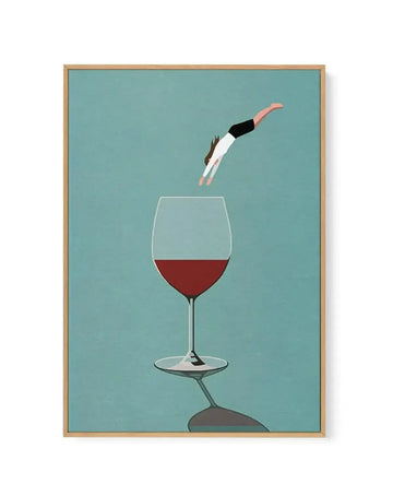 Framed canvas art print featuring a minimalist illustration against a teal background. A figure in a black top and white pants dives headfirst into a wine glass filled with deep red wine. The glass sits on a stem mounted on a dark stone base. The artwork uses a flat, graphic style with clean lines and a limited colour palette of teal, burgundy, black, cream, and grey. The canvas is surrounded by a natural wood frame with a white border.