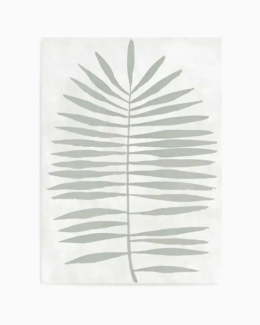 Art print featuring a single, large-scale palm frond illustration in a muted sage green against a soft white background. The frond has a central stem with numerous elongated, slightly curved leaves extending outwards, depicted with a loose, organic brushstroke quality.