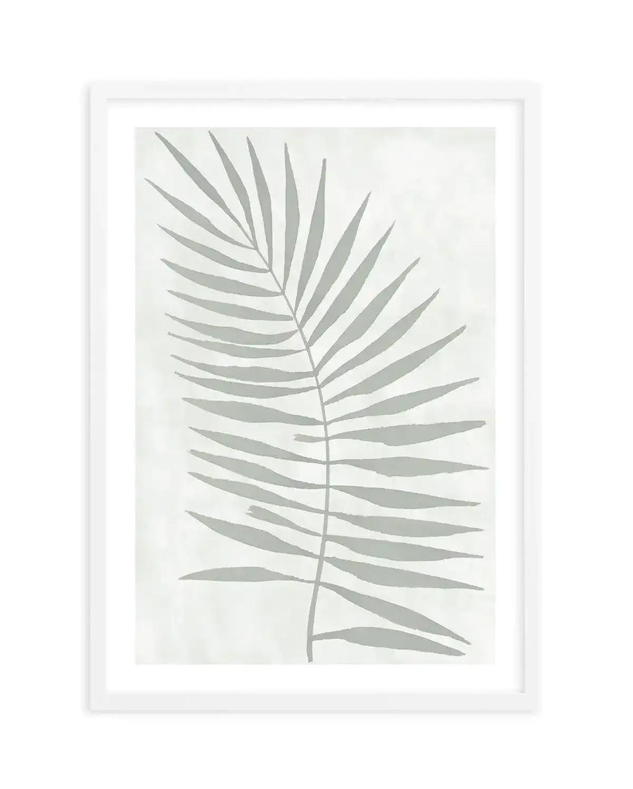 Watercolour art print featuring a single palm frond in a muted sage green, with soft brushstroke detail on a light cream background, printed on fine art paper and displayed in a white frame with white border