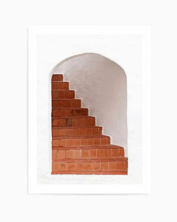 Art print featuring a minimalist photograph of a terracotta staircase ascending within a white arched alcove. The steps are made of square terracotta tiles in a warm, earthy orange-brown hue, contrasting with the stark white, textured walls of the archway.