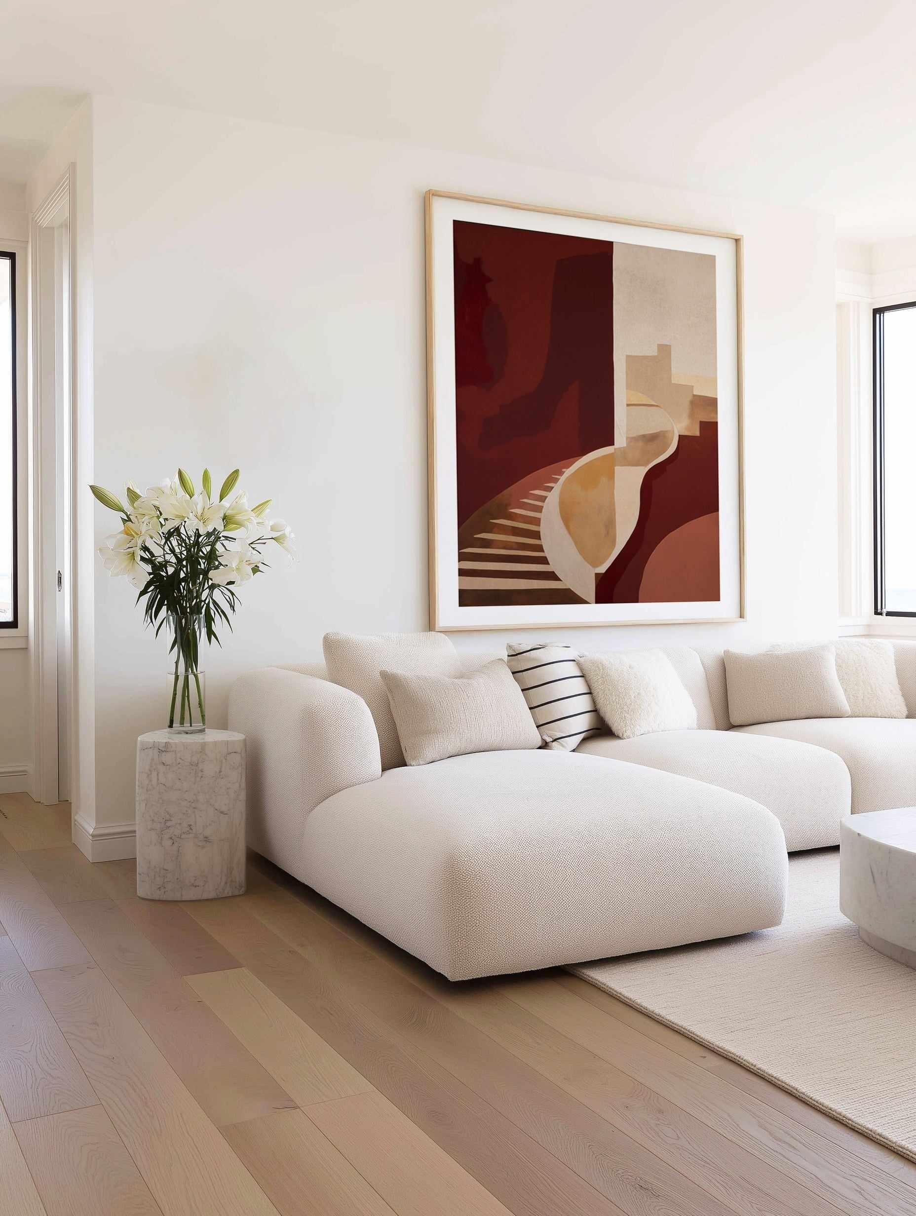Modern living room with a white sofa, abstract burgundy wall art, and decorative elements.