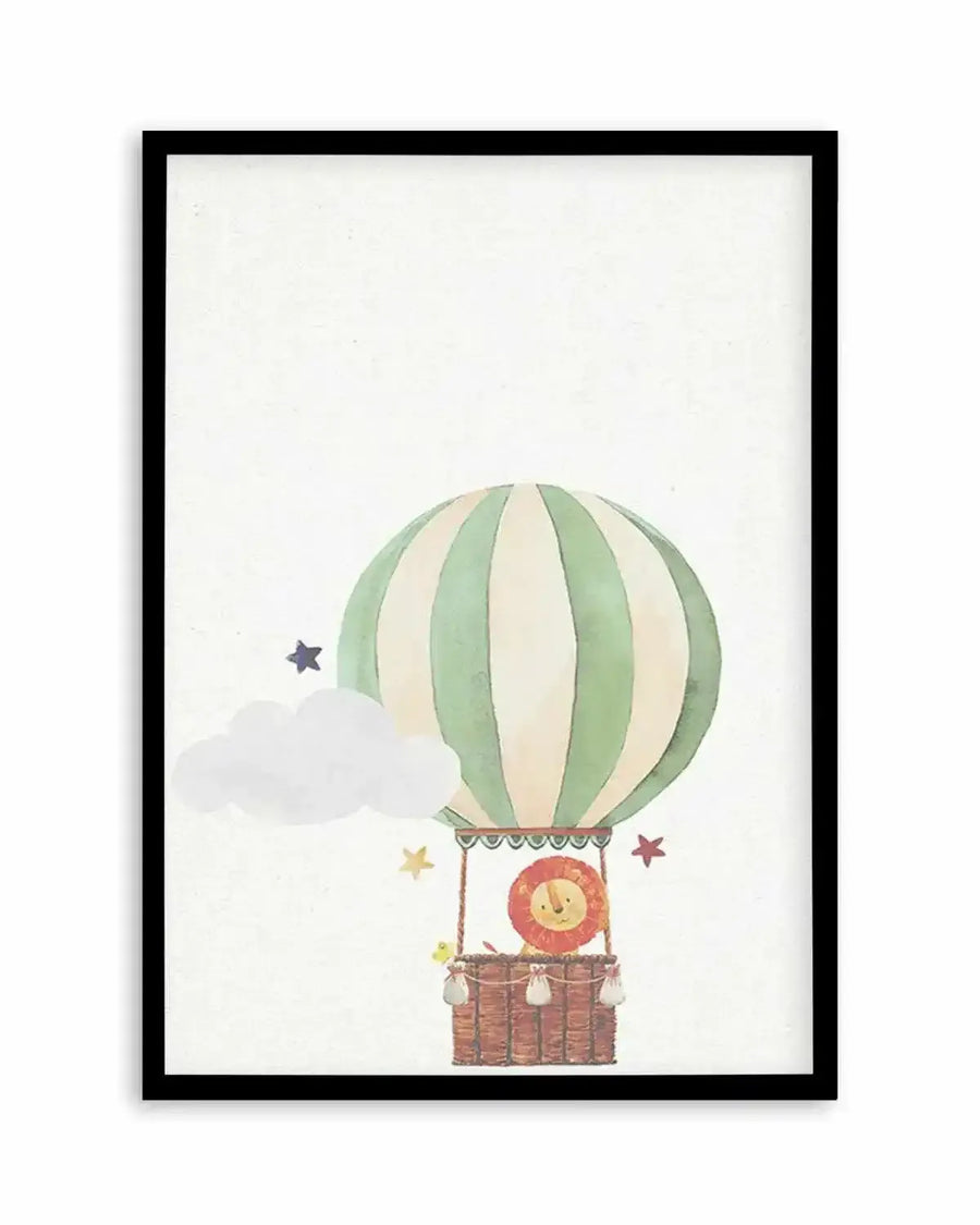 Watercolour art print featuring a hot air balloon with vertical cream and sage green stripes, carrying a lion with a red mane in a woven basket. The scene includes a white cloud and scattered stars in purple, yellow, and red, all on a textured white background, displayed in a black frame with a white border.