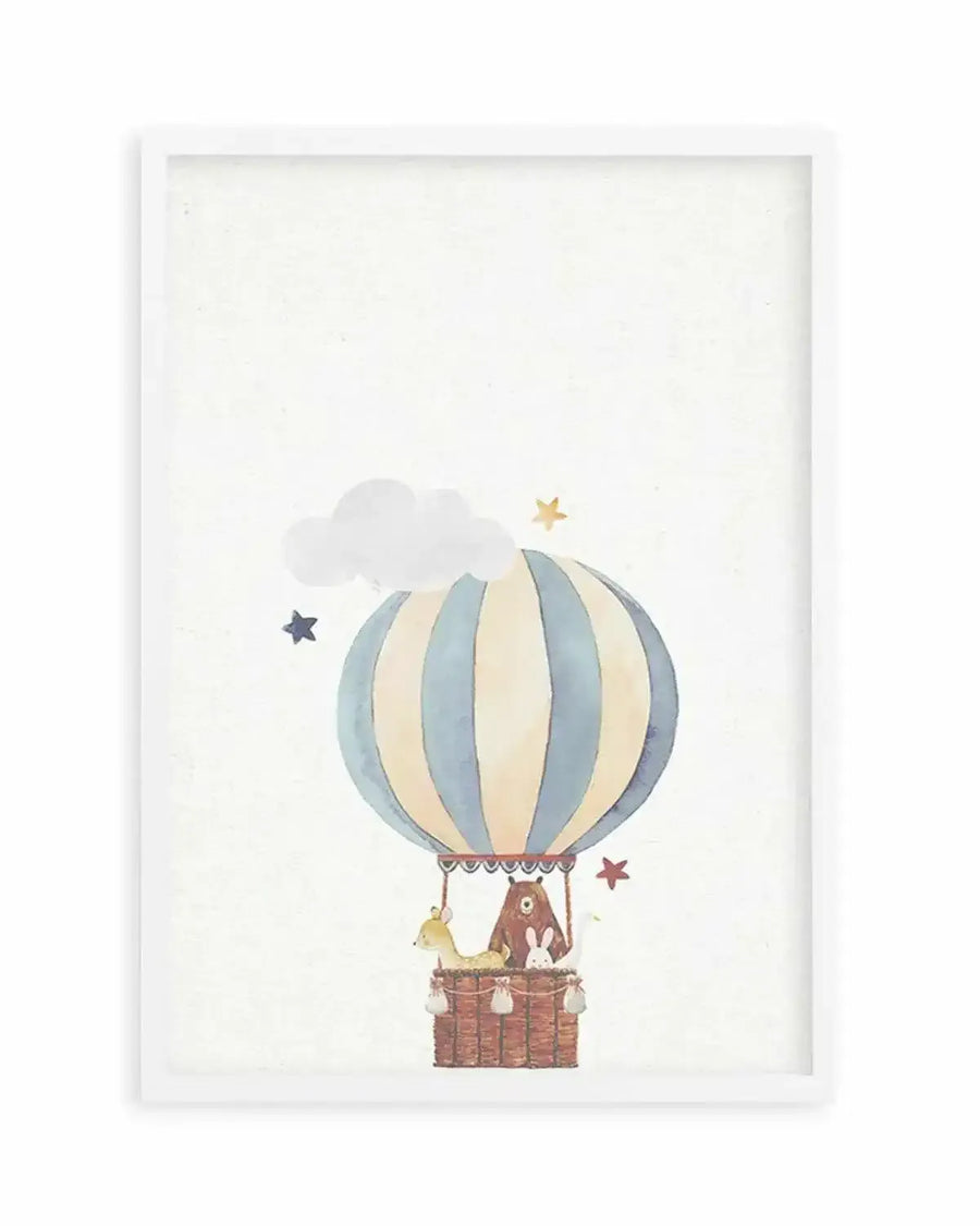 Watercolour art print featuring a hot air balloon with vertical pale blue and cream stripes, carrying a brown bear, a fawn, and two white bunnies in a woven basket. The background is a soft cream with a white cloud and scattered stars in pale yellow, dark blue, and red, displayed in a white frame with a white border.