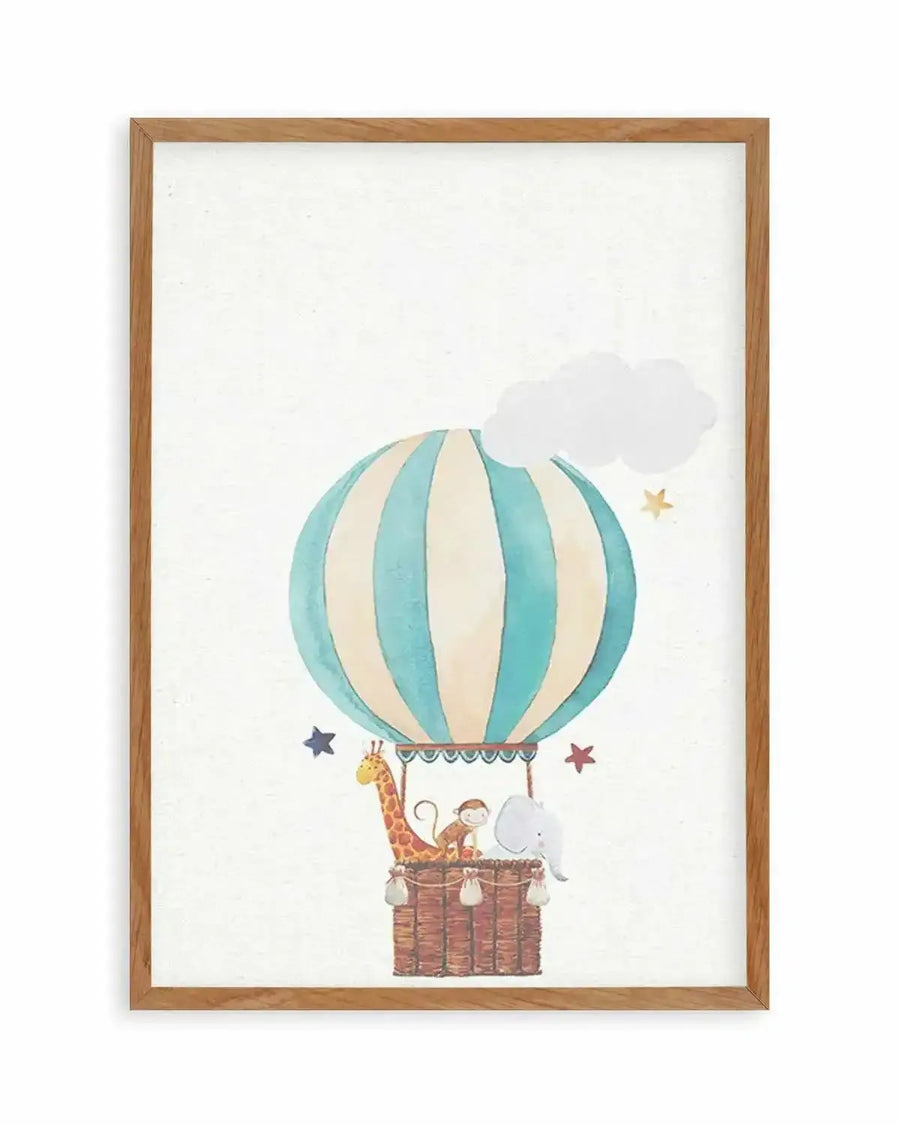 Watercolour art print featuring a hot air balloon with cream and teal stripes, carrying a giraffe, a monkey, and an elephant in a woven basket. The background is a soft white with a few scattered stars in blue, red, and yellow, and a small white cloud. The print is displayed in a natural oak frame with a white border.