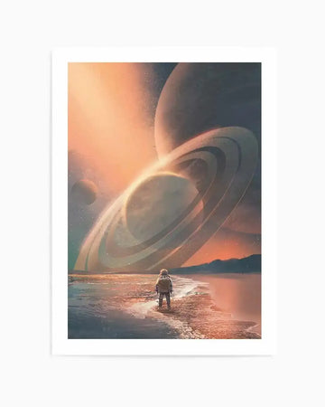 Science fiction art print depicting an astronaut standing on a beach, looking out at a vast alien landscape. The sky is a dramatic blend of orange, pink, and deep blue, illuminated by a distant sun. Large ringed planets dominate the horizon, with one prominent planet featuring multiple glowing rings. The astronaut, wearing a white and grey suit, stands on a sandy shore where gentle waves lap at the edge. The overall mood is one of wonder and solitude.